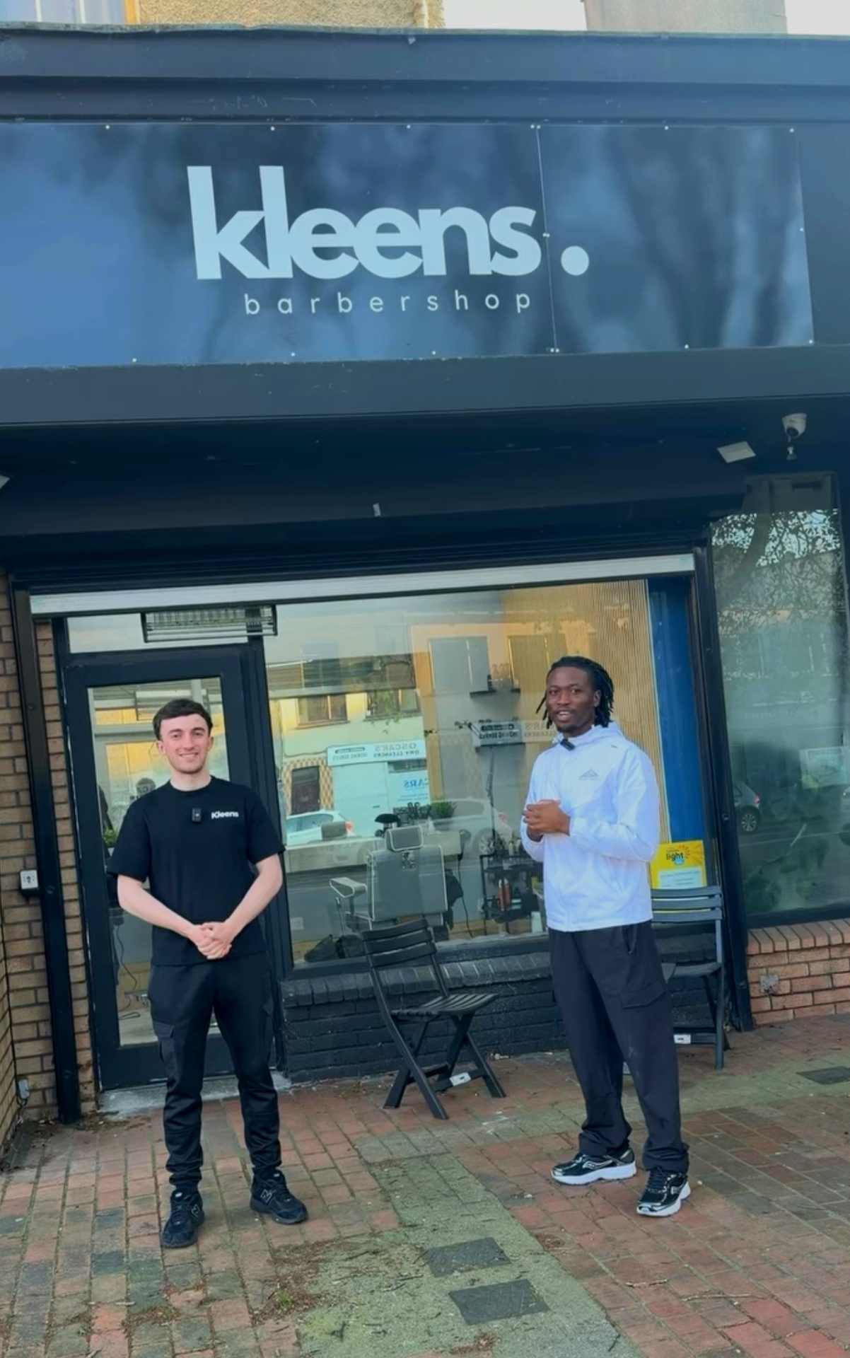 Kleens Barbershop owners standing in front of the shop